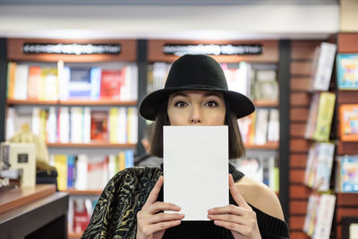 Portrait of woman holding book