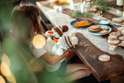 High angle view of woman having food on table