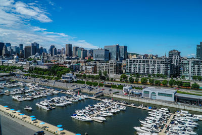 High angle view of city buildings against blue sky