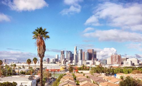 View of cityscape against cloudy sky