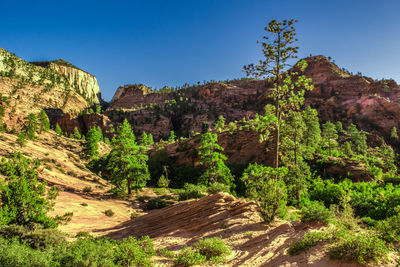 Scenic view of rocky mountains against clear blue sky