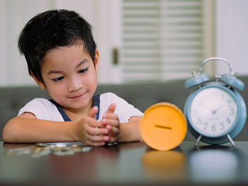 Portrait of boy on table at home