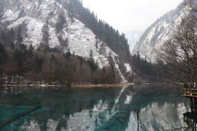 Beatiful landscape of a lake between mountains with reflexion of trees in the water in jiuzhaigou 