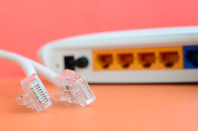 Close-up of computer cable and router on table