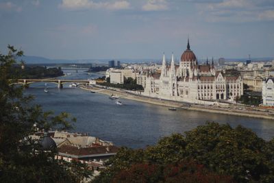 High angle view of river amidst buildings against sky