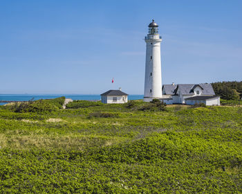 Low angle view of lighthouse against blue sky