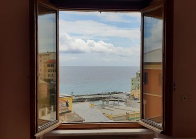 Panoramic view of sea seen through window