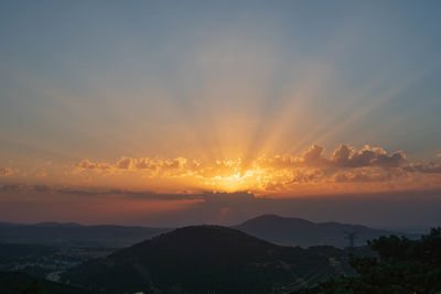 Scenic view of silhouette mountains against sky during sunset