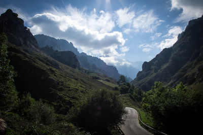 Road amidst trees against sky