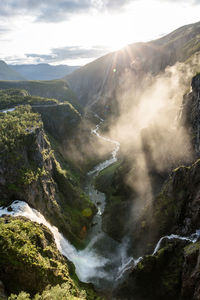 Scenic view of waterfall against sky