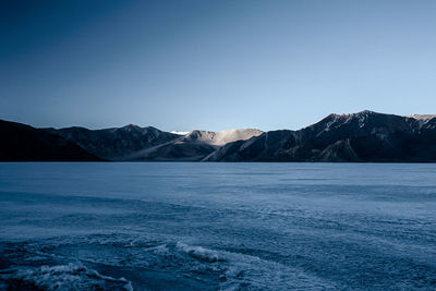 Scenic view of mountains against clear blue sky