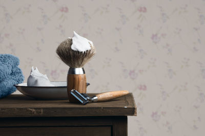 Close-up of shaving equipment on table