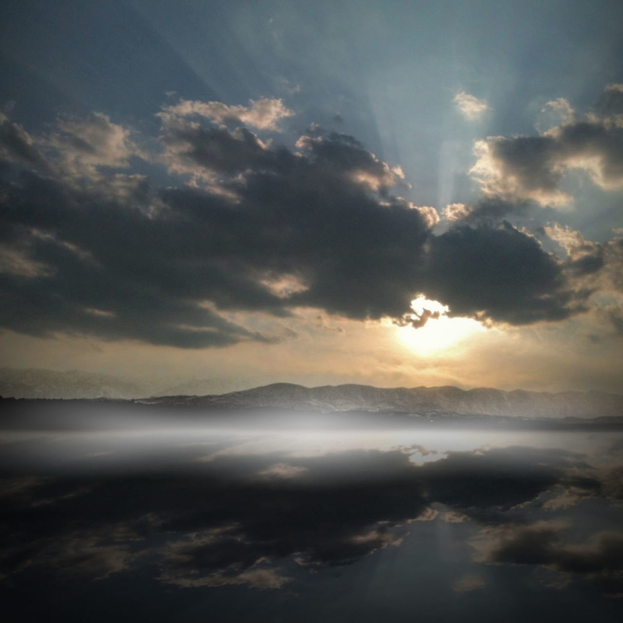 scenics, tranquil scene, beauty in nature, sunset, sky, tranquility, cloud - sky, nature, idyllic, cloudy, sun, mountain, cloudscape, cloud, majestic, sunbeam, weather, sunlight, orange color, dramatic sky