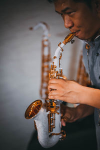 Midsection of man playing guitar