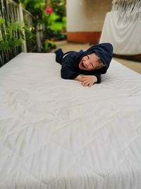 Portrait of girl lying on bed at home