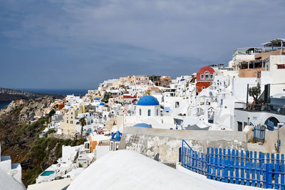 Buildings in town against sky during winter