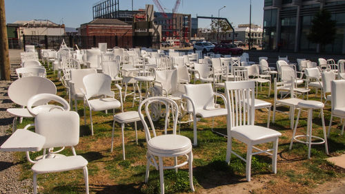 Empty chairs and table against buildings