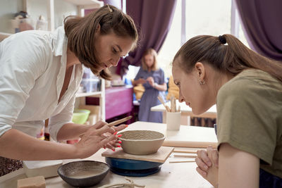 Woman making ceramic pot on workshop. concept for woman with hobbys. handcraft product. teacher 