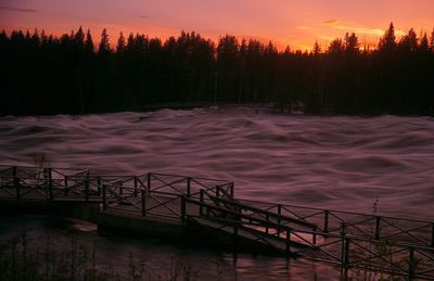 Scenic view of river against orange sky