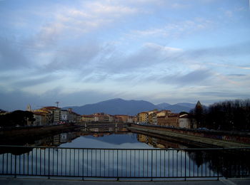 Bridge over river with city in background