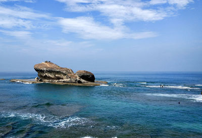 Big rock in the middle of the blue ocean