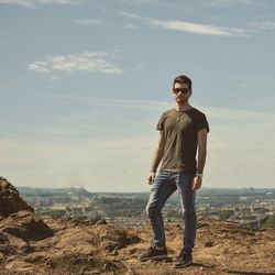 Portrait of smiling man standing on rock