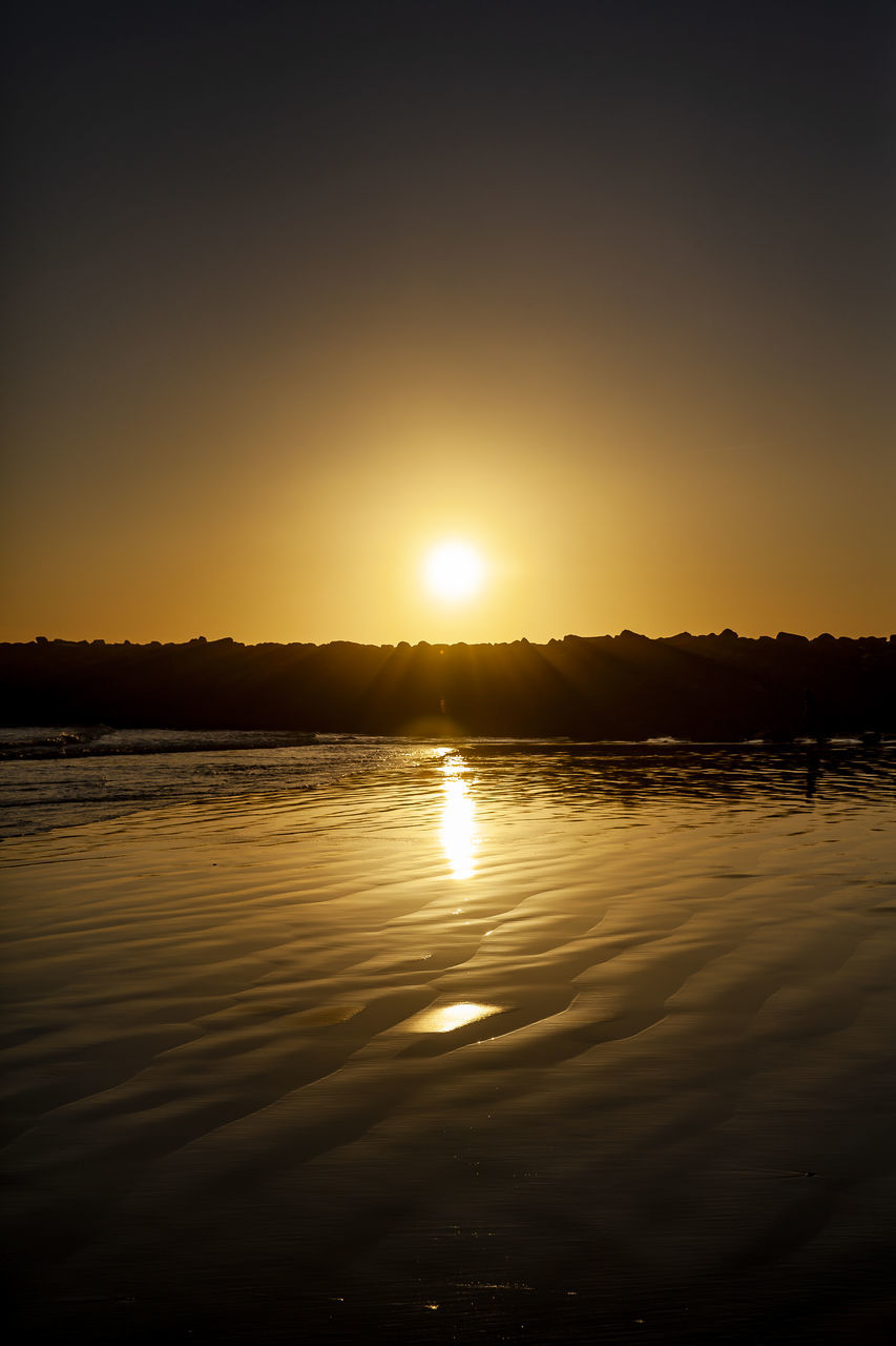 SCENIC VIEW OF LAKE AGAINST ORANGE SKY