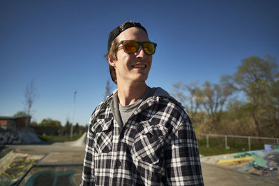 Young canadian man smiling happily