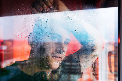 Depressed man looking through window