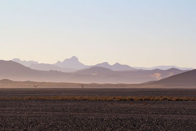 Scenic view of landscape and mountains against sky