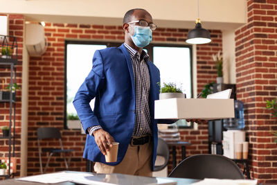 Portrait of man standing in office