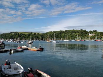 Boats moored in sea against sky