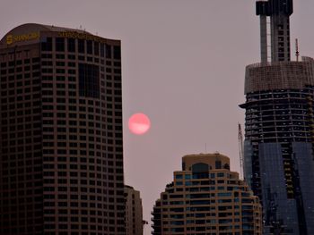 Low angle view of buildings against sky during sunset