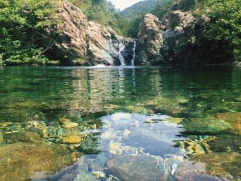 Scenic view of river flowing through rocks