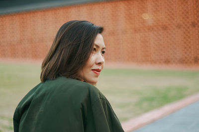 Portrait of a young woman looking away