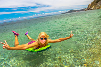 Full length of woman wearing mask swimming in sea