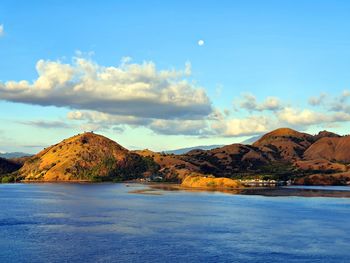 Scenic view of sea and mountains against sky