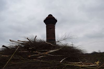 Low angle view of lighthouse against cloudy sky