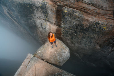 Woman standing by rock in water