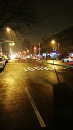 Illuminated city street at night