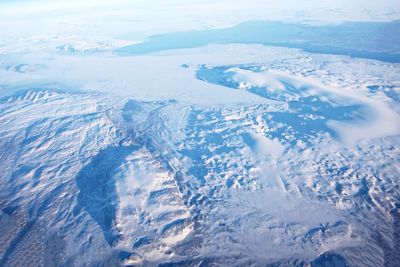 Aerial view of snowcapped mountains and sea
