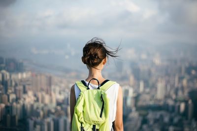 Rear view of woman standing against sky