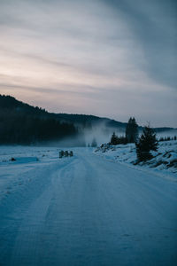 Scenic view of landscape against sky during winter