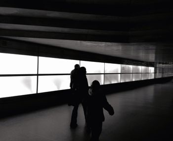 Woman standing by railing