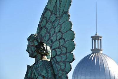 Low angle view of statue against blue sky