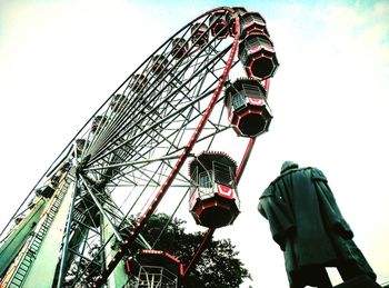 Low angle view of ferris wheel against sky