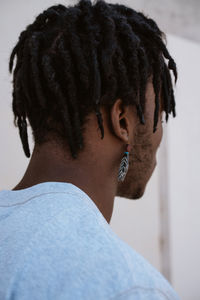 Black man with earring portrait on a monochrome background