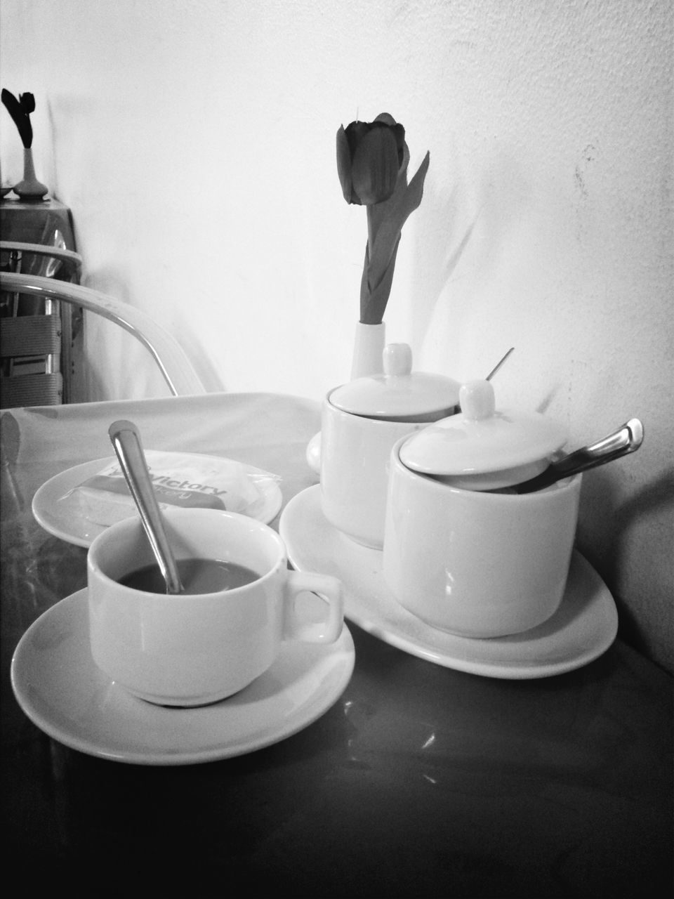 indoors, table, still life, coffee cup, drink, refreshment, home interior, food and drink, cup, coffee - drink, wall - building feature, one person, chair, bottle, reflection, bathroom, empty, coffee, sitting, hygiene