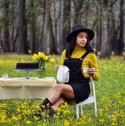 Full length of woman sitting in park