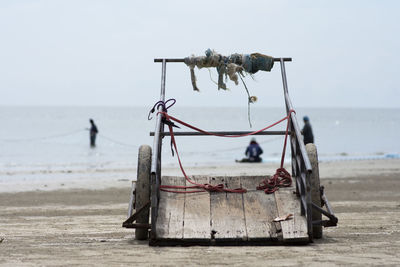 Abandoned ship on beach against sky